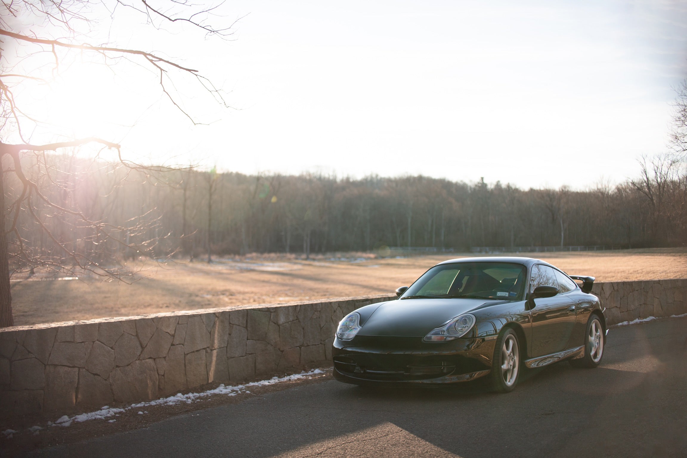 files/grey-car-is-parked-by-a-stone-wall.jpg